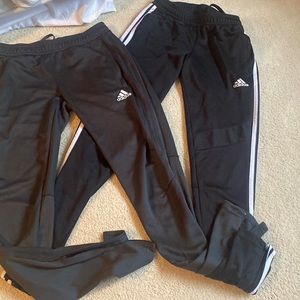 Two pair of Adidas Track Pants. Black with white stripes. Grey on Grey stripes
